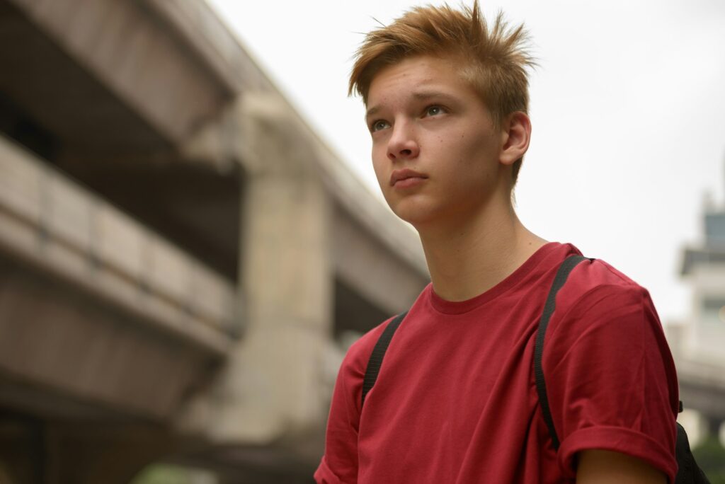 Young handsome teenage boy in the city outdoors
